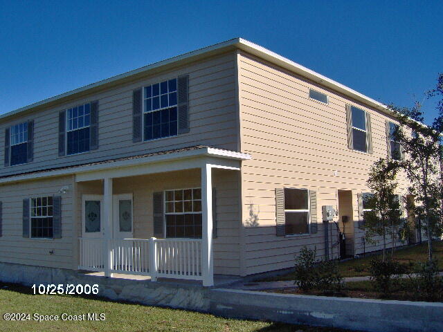 a view of a house with wooden fence