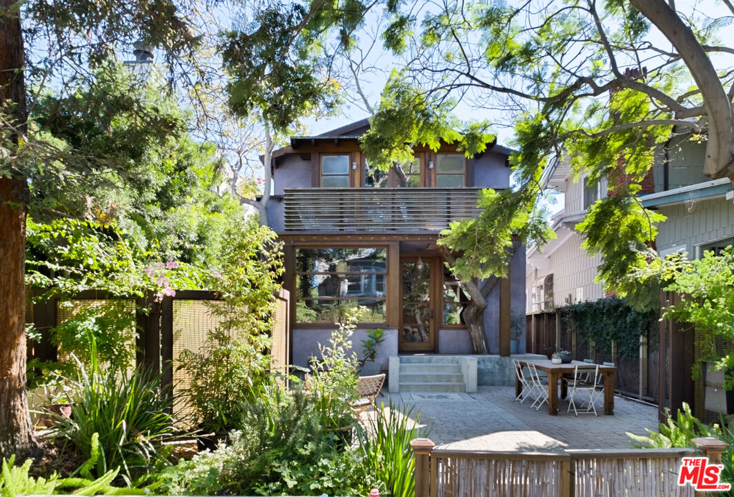 a view of patio with table and chairs and potted plants