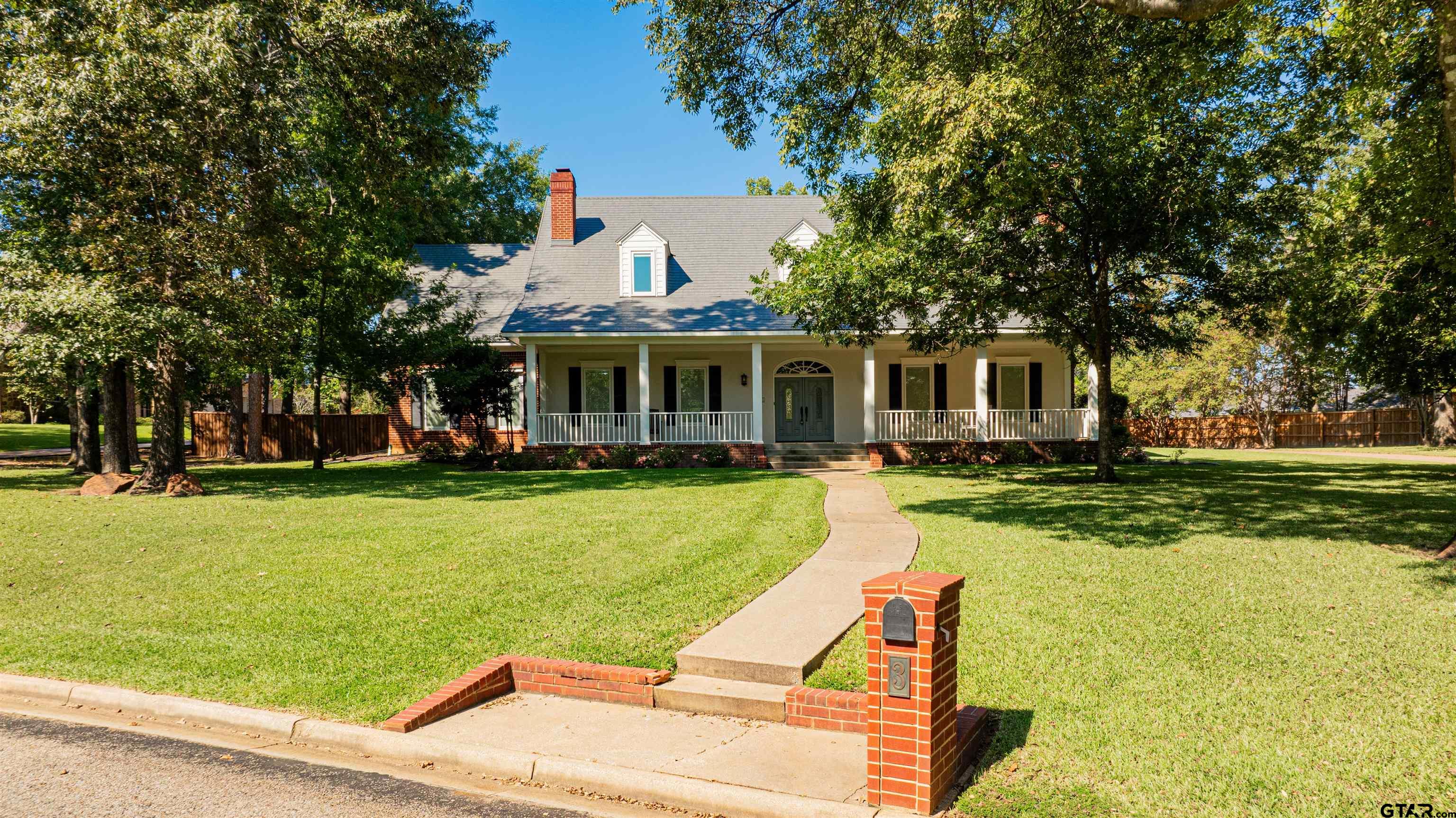 a view of a house with swimming pool and a yard