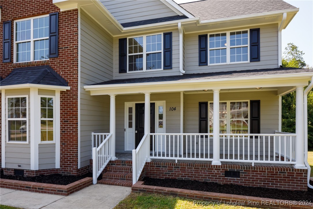 a view of a brick house with large windows