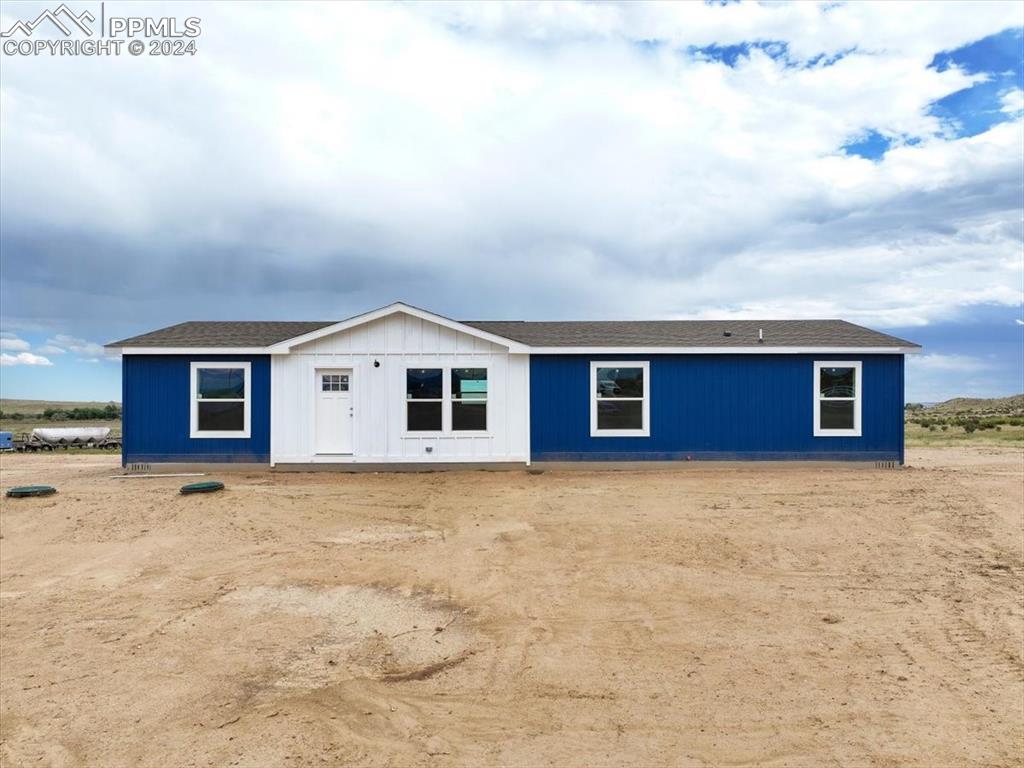 a big house with yard in front of it