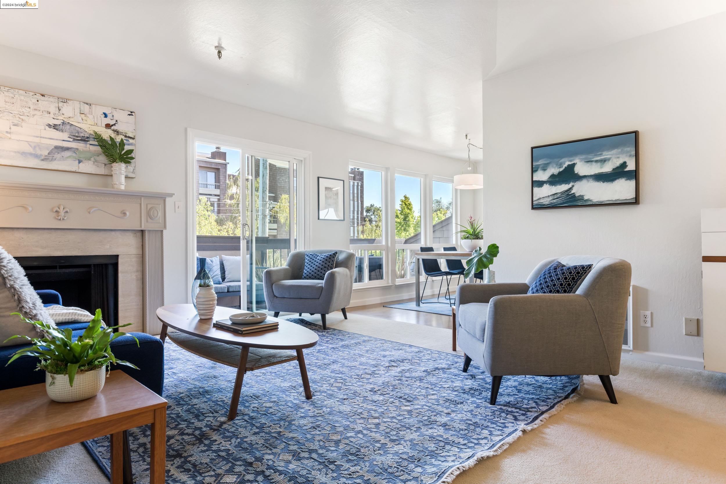 a living room with furniture potted plant and a fireplace