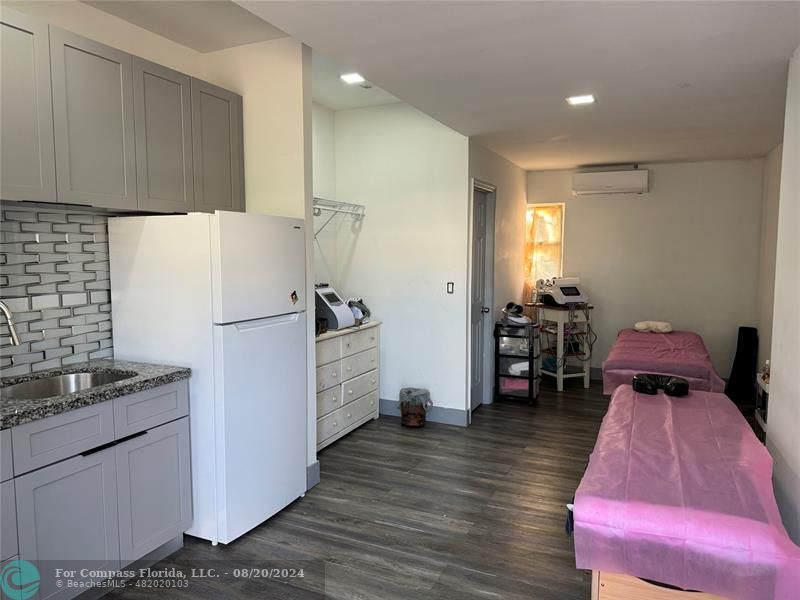 a kitchen with refrigerator a table and chairs