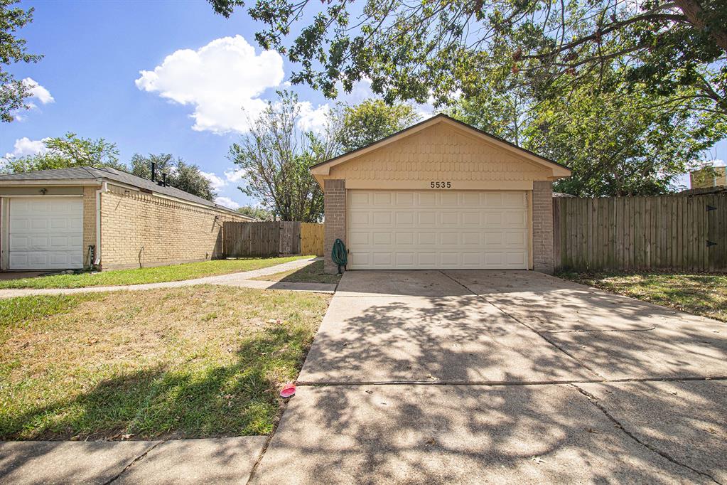 a view of garage yard and tree