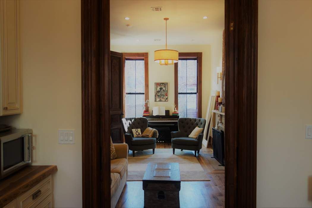 a living room with furniture and a chandelier