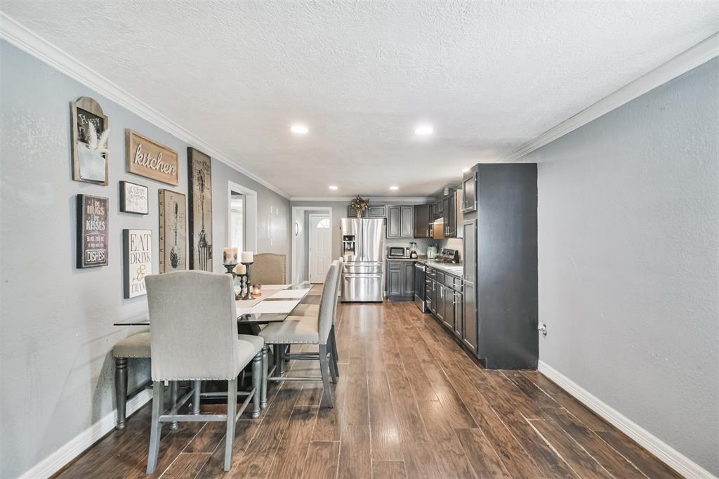 a dining room with furniture and wooden floor