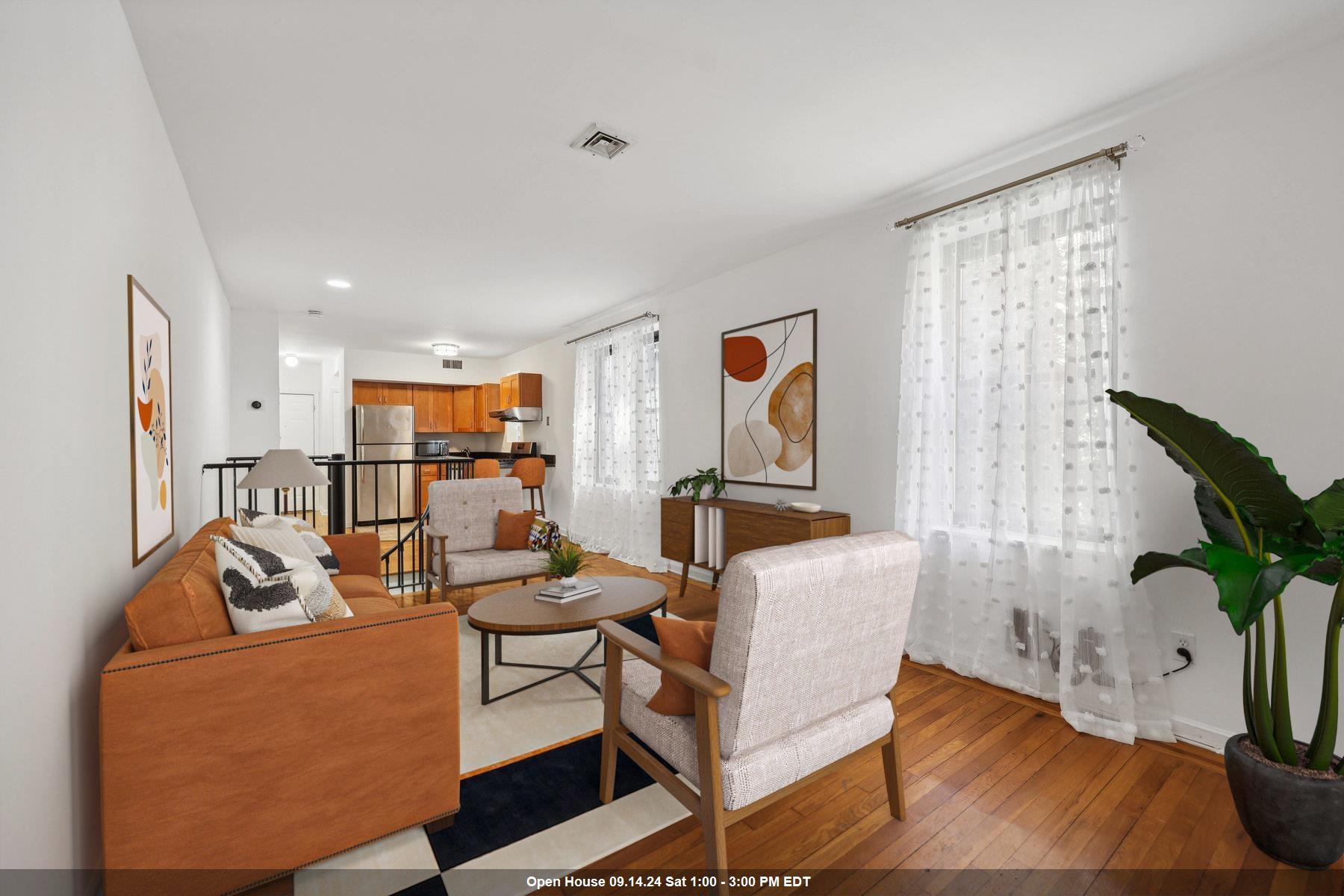 a living room with furniture and a potted plant