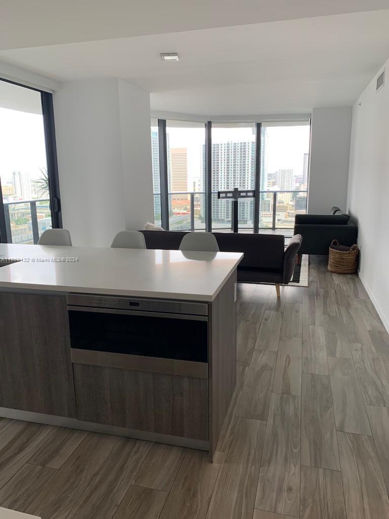 a view of a room with wooden floor and furniture