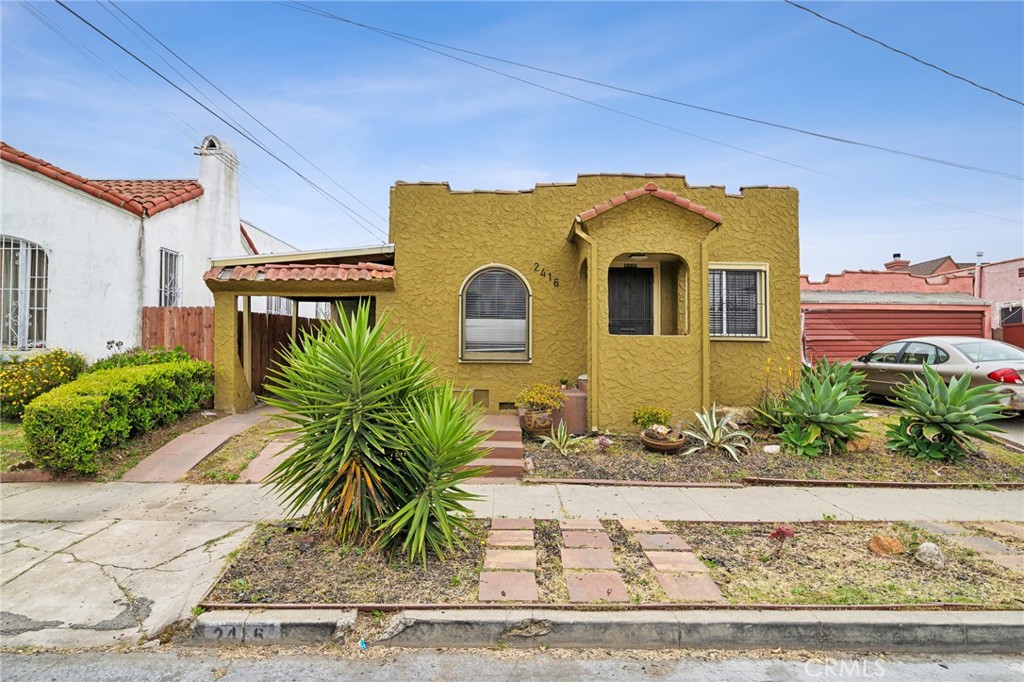 a front view of a house with garden