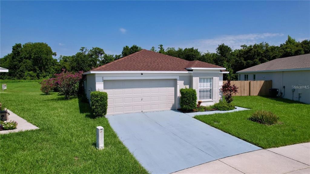 a front view of a house with a yard and garage