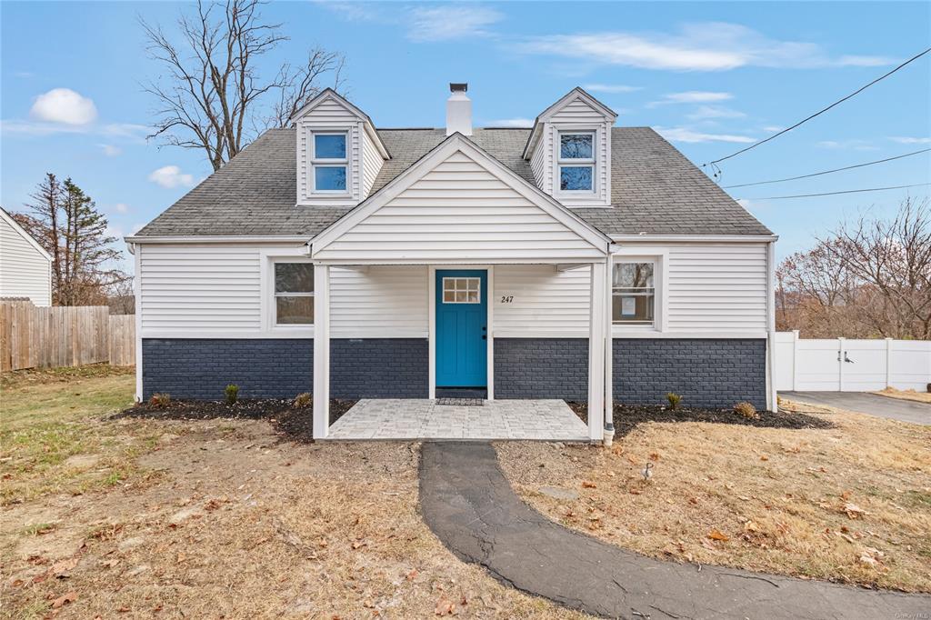 Cape Cod style home with a front lawn