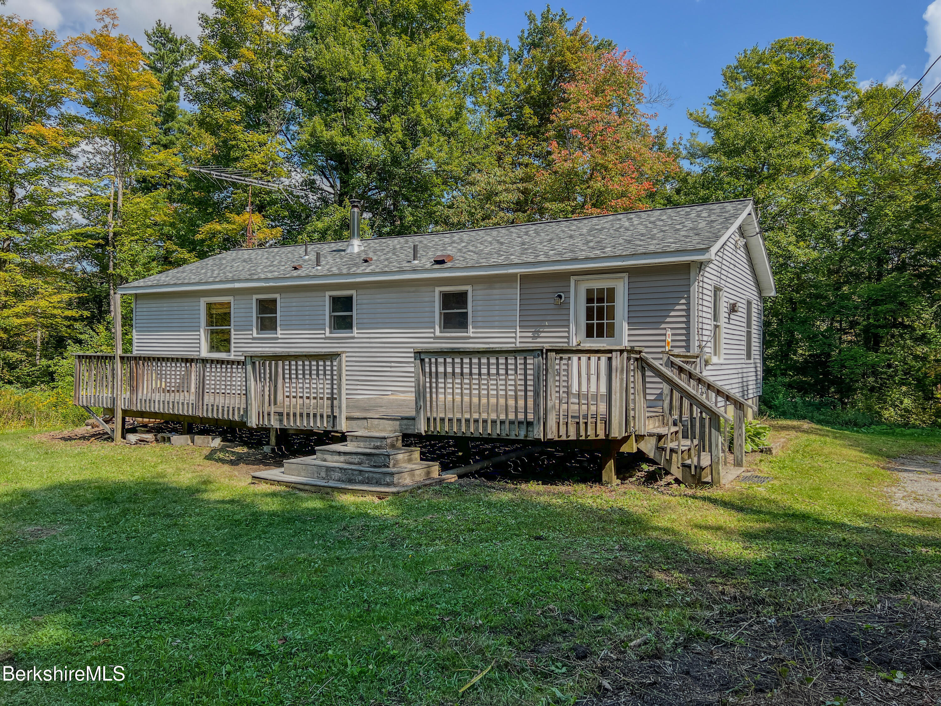 a view of a house with a backyard and a deck