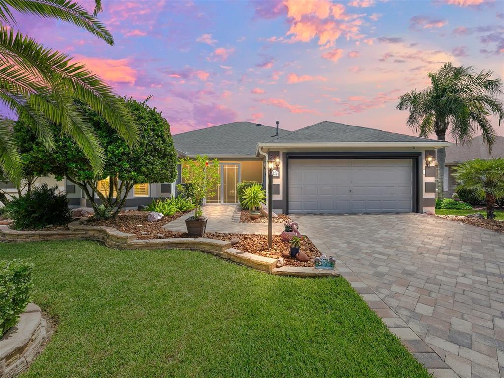 Gorgeous curb appeal! Paver drive, elevated stone landscaping beds, AUTO garage screen.