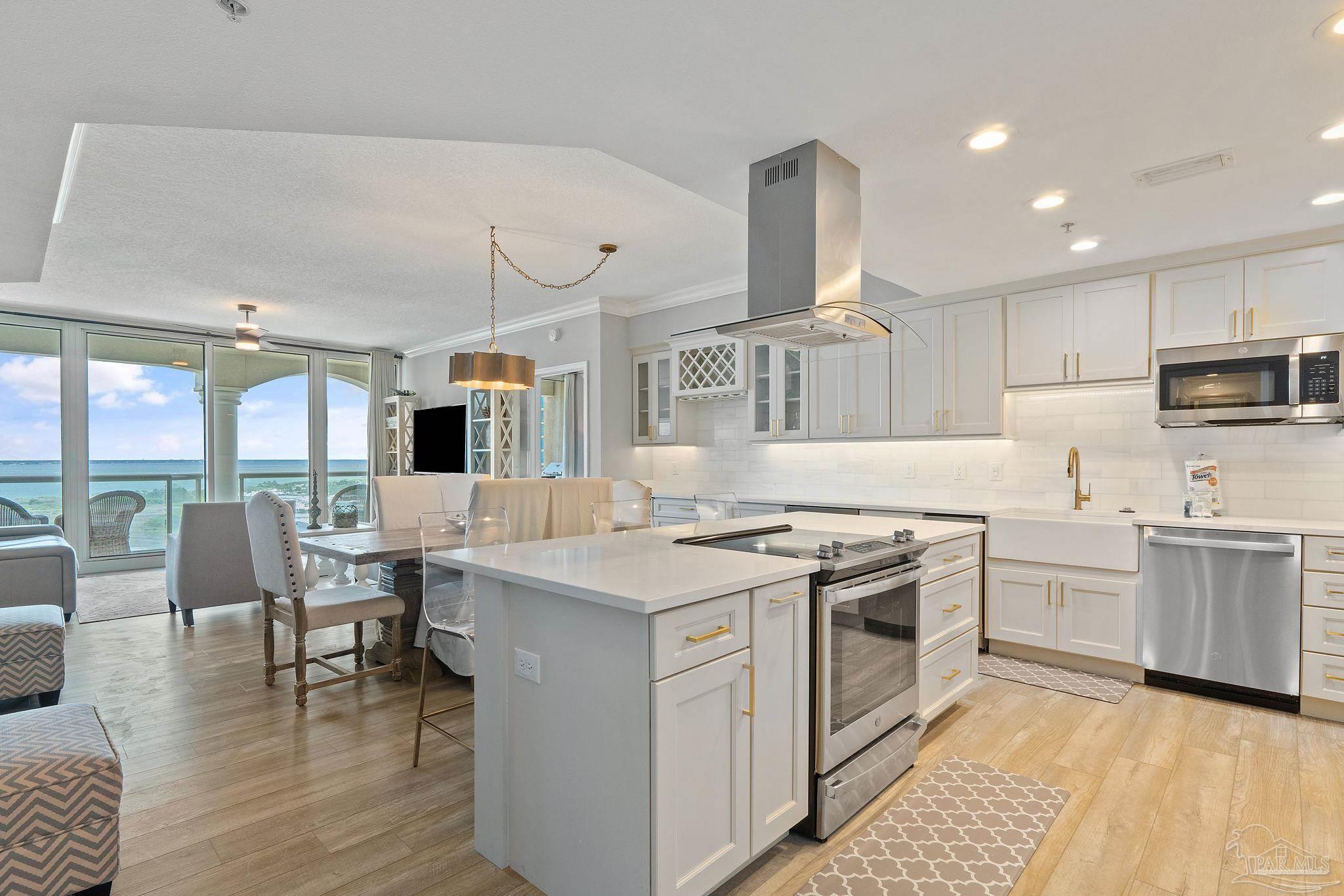 a kitchen with granite countertop a sink stove and cabinets