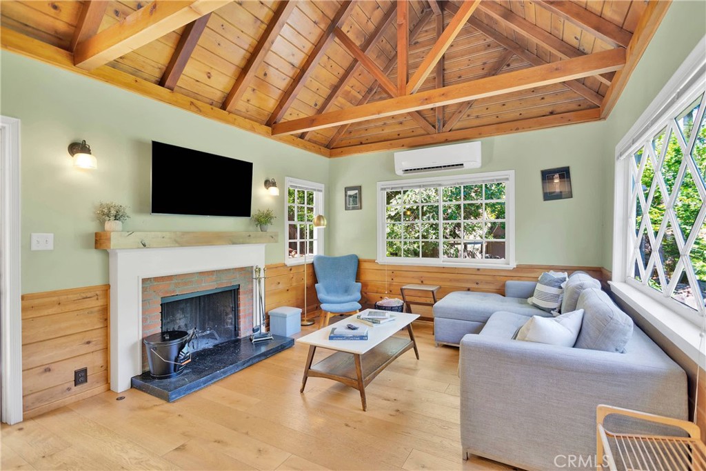 a living room with furniture a fireplace and a flat screen tv