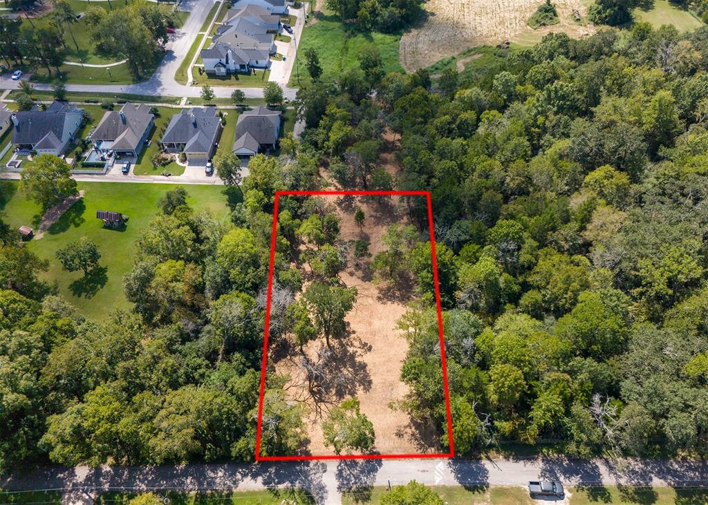 an aerial view of a houses with yard