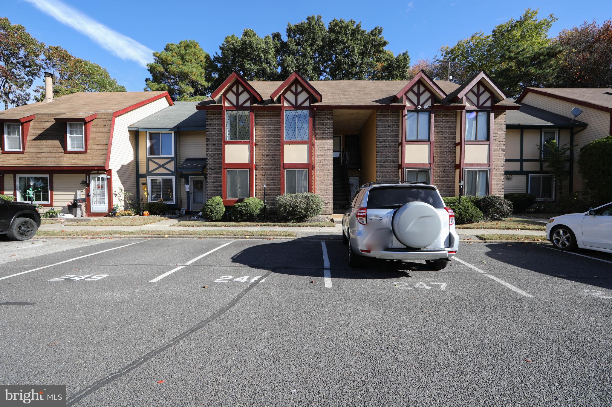 a front view of a residential apartment building with a yard