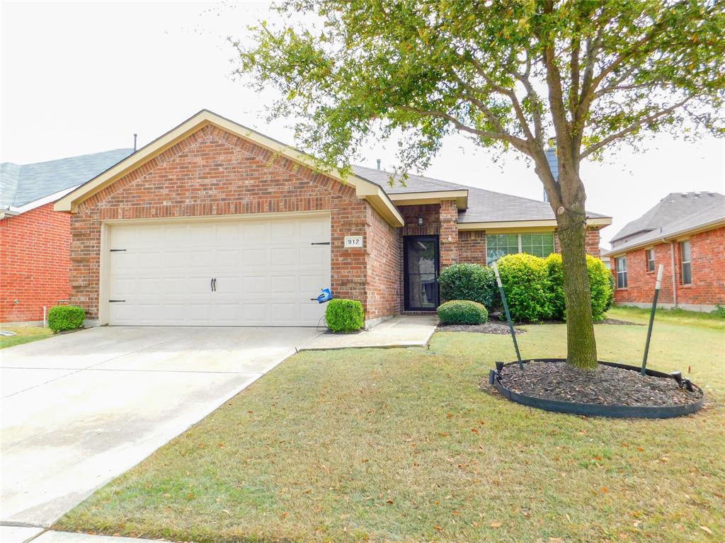 a house that has a tree in front of it