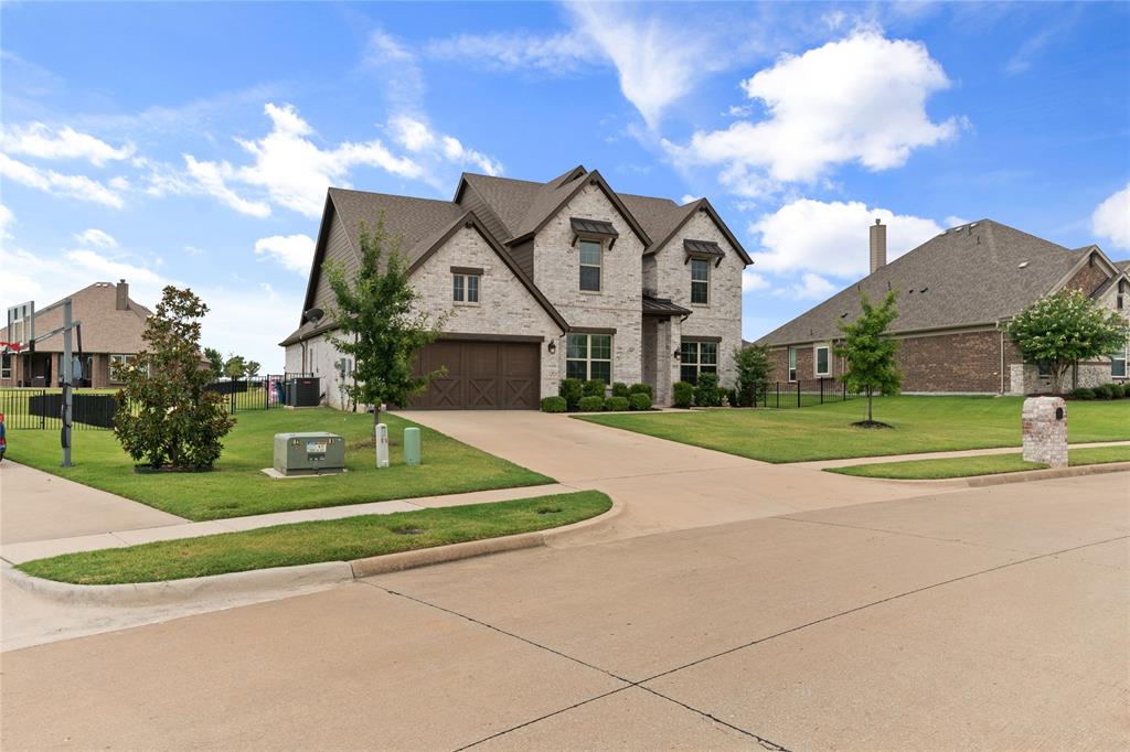 a view of a house with a big yard and large trees