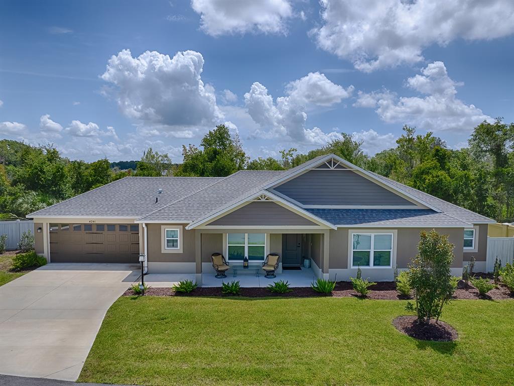 a front view of house with yard and green space