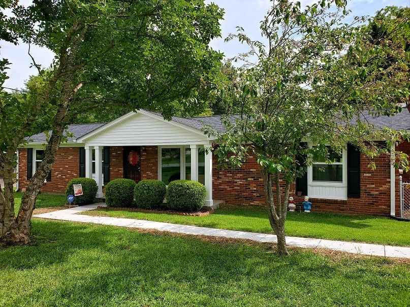 a front view of a house with garden