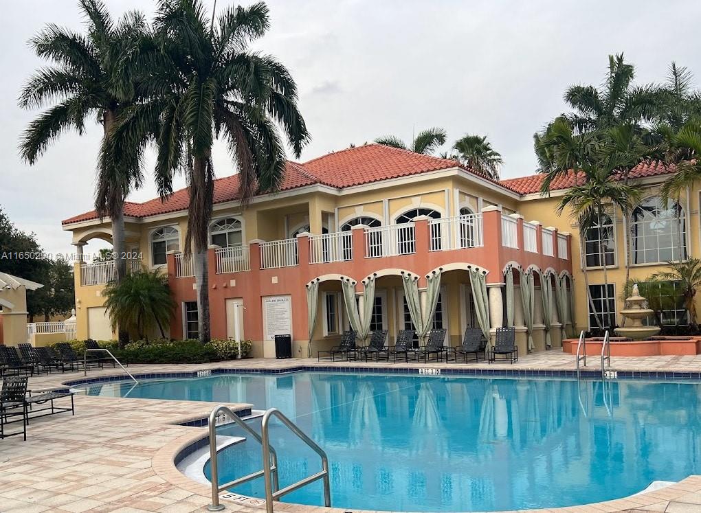 a view of house with swimming pool and patio