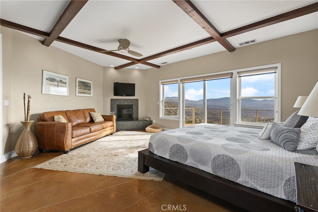 a spacious bedroom with a bed couch and a large window