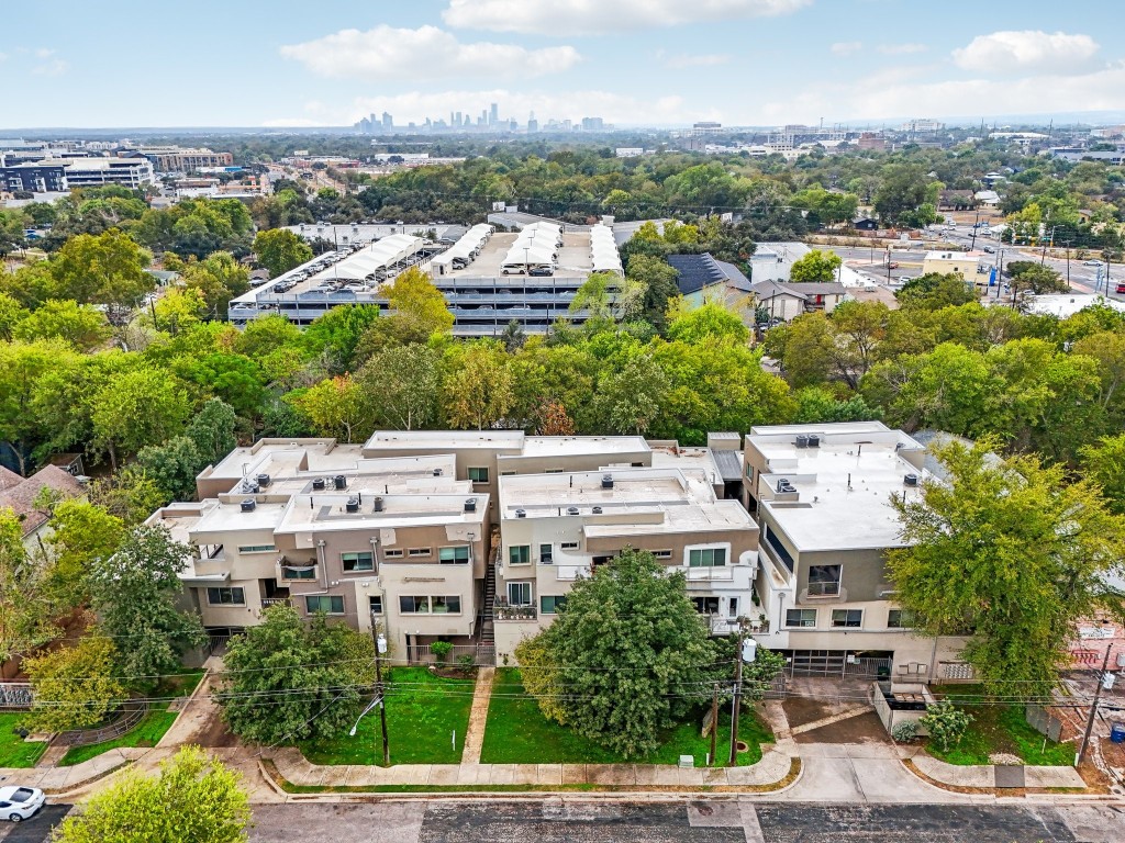 an aerial view of residential houses with city view