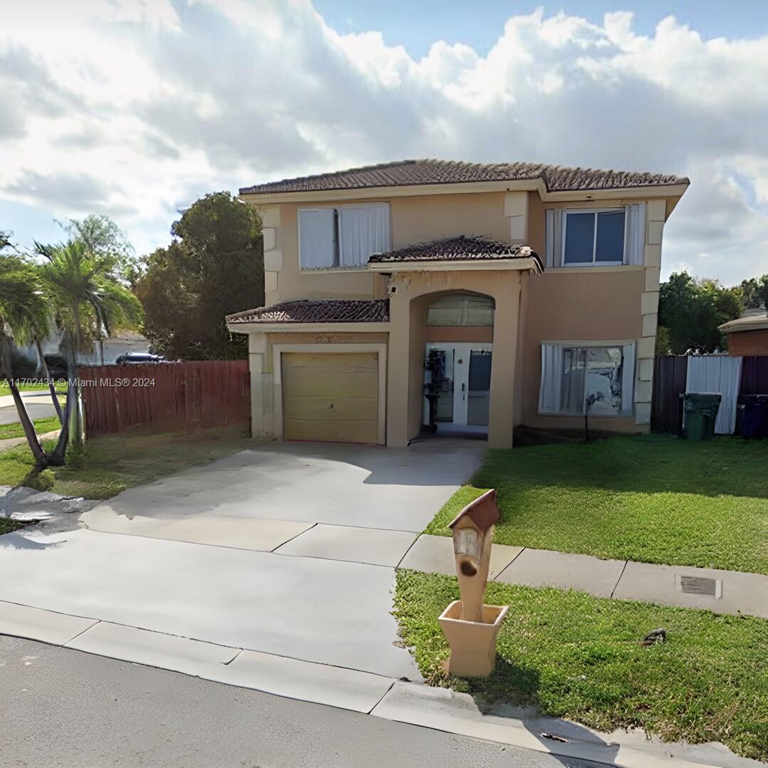 a front view of house with yard and outdoor seating