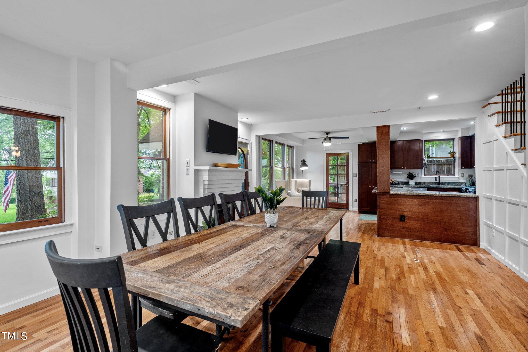 a view of a dining room with furniture and a kitchen