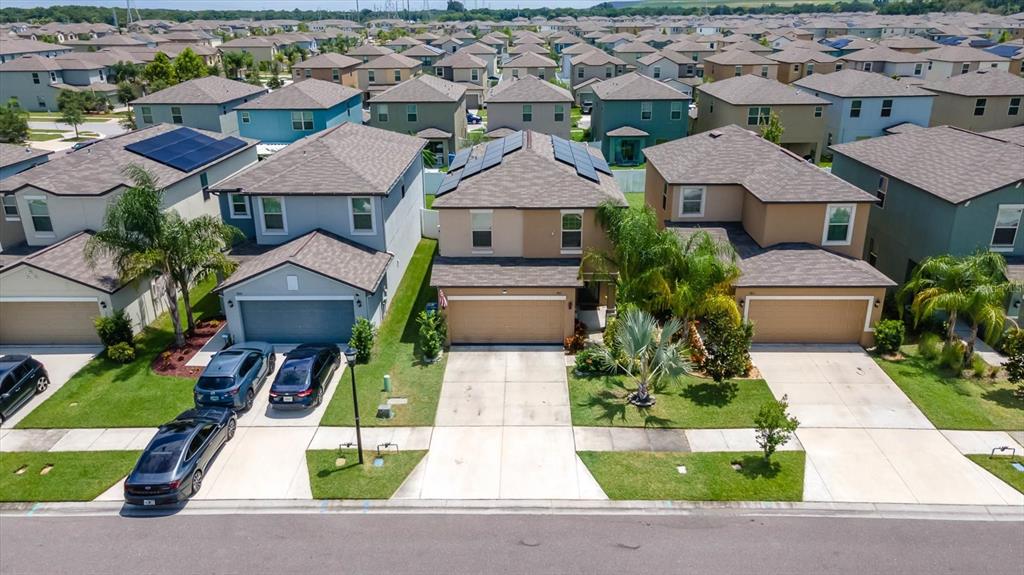 an aerial view of multiple houses with yard