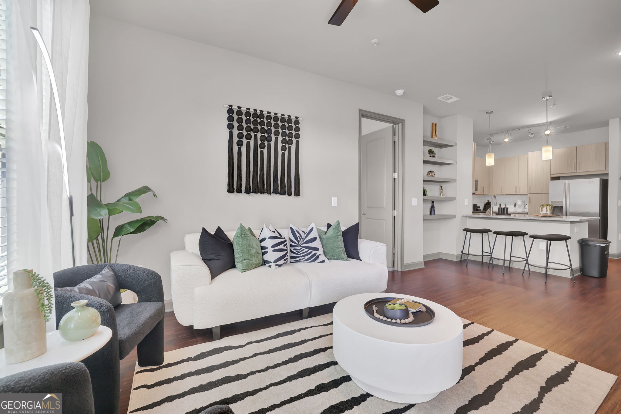 a living room with furniture and a wooden floor