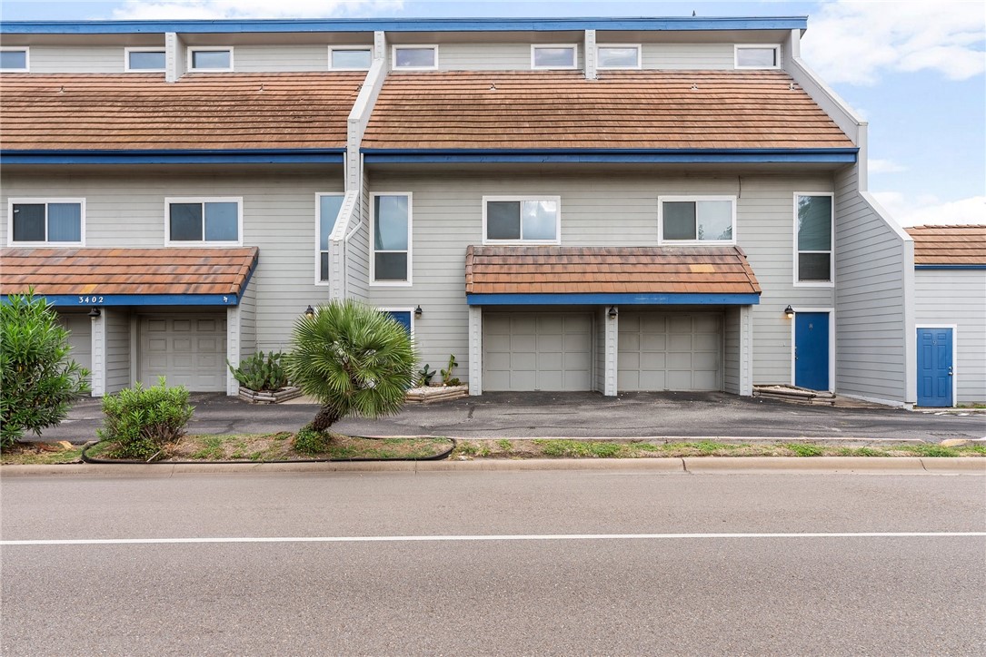 a view of a house with a patio and a yard