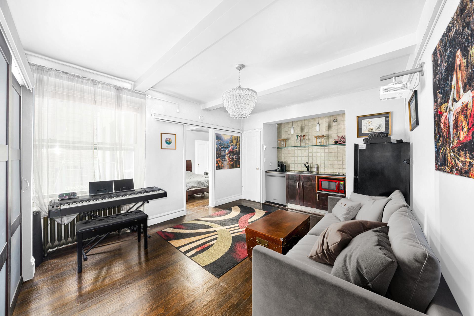 a living room with furniture fireplace and a window