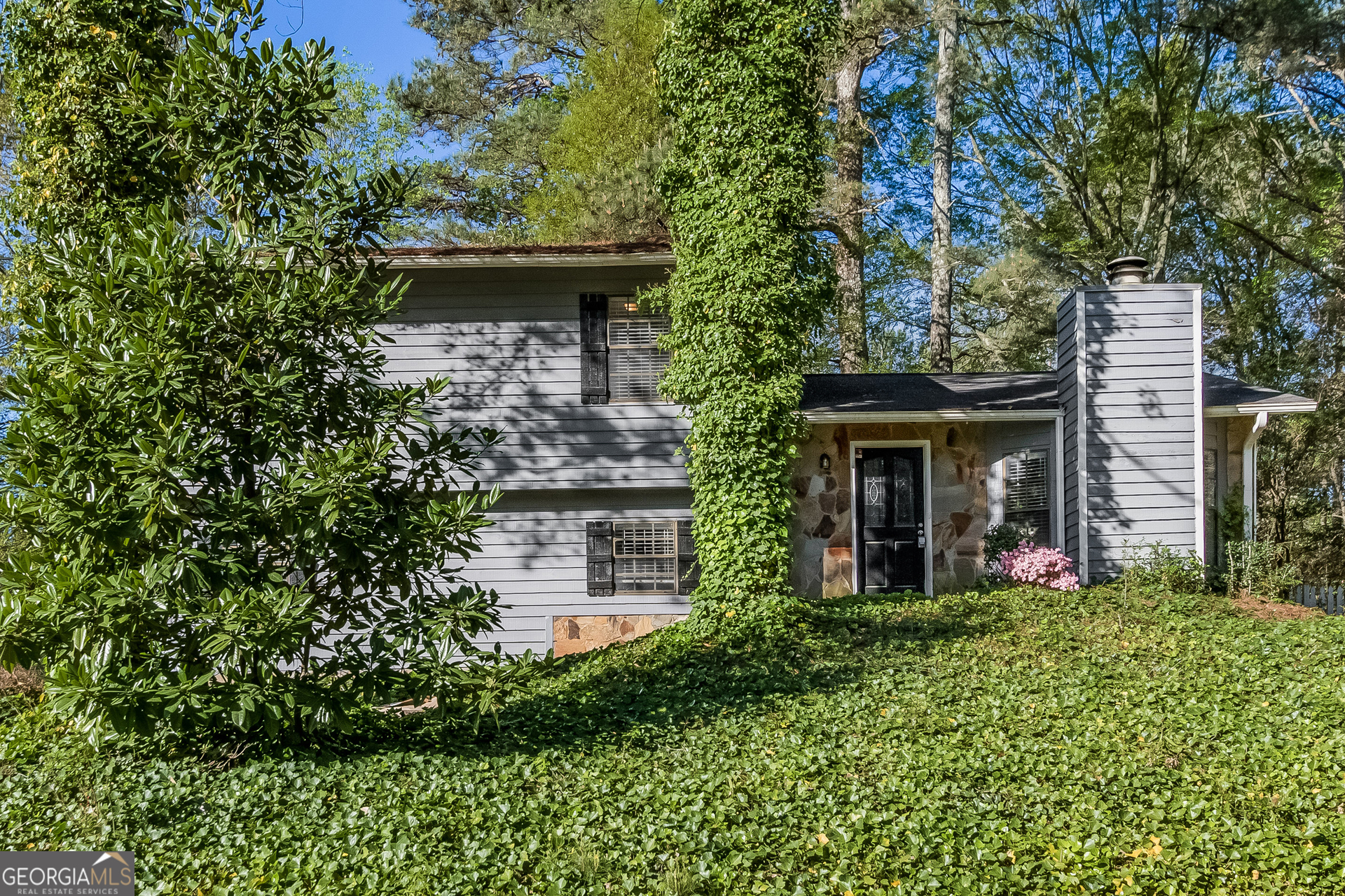 a front view of a house with garden