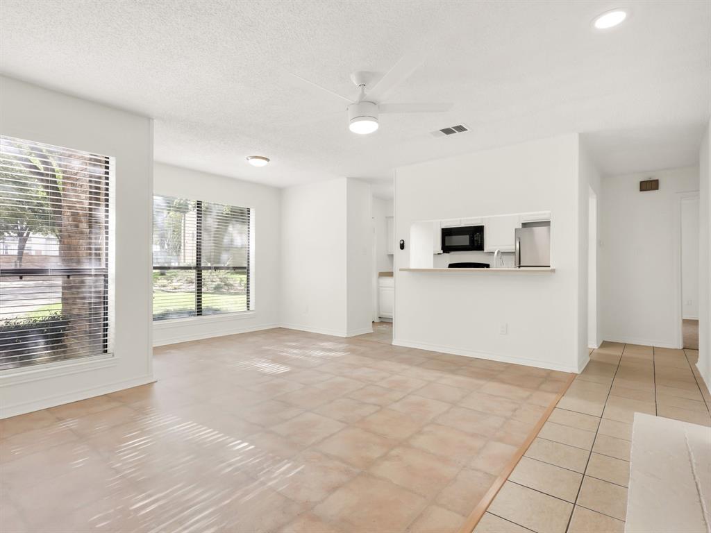 a view of a kitchen with microwave and windows