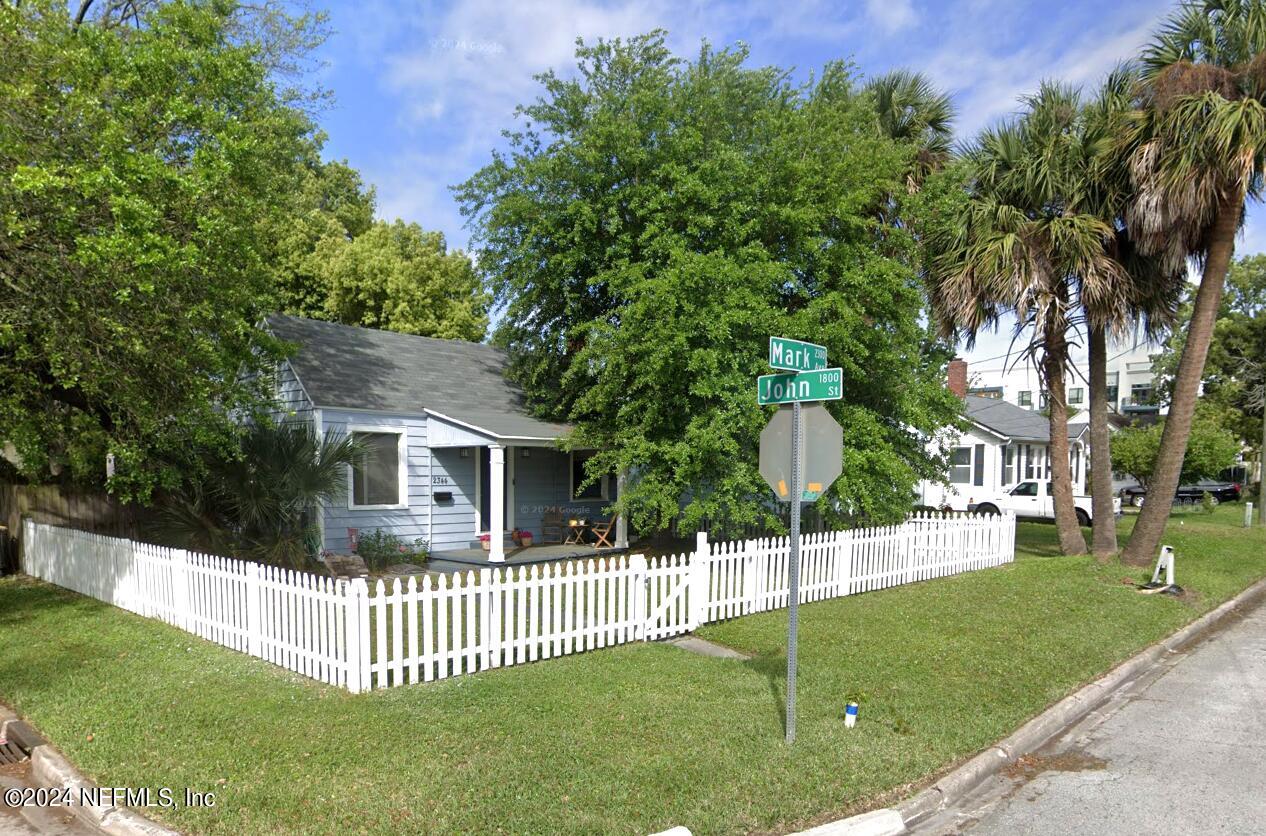 a view of a house with a yard and a garden