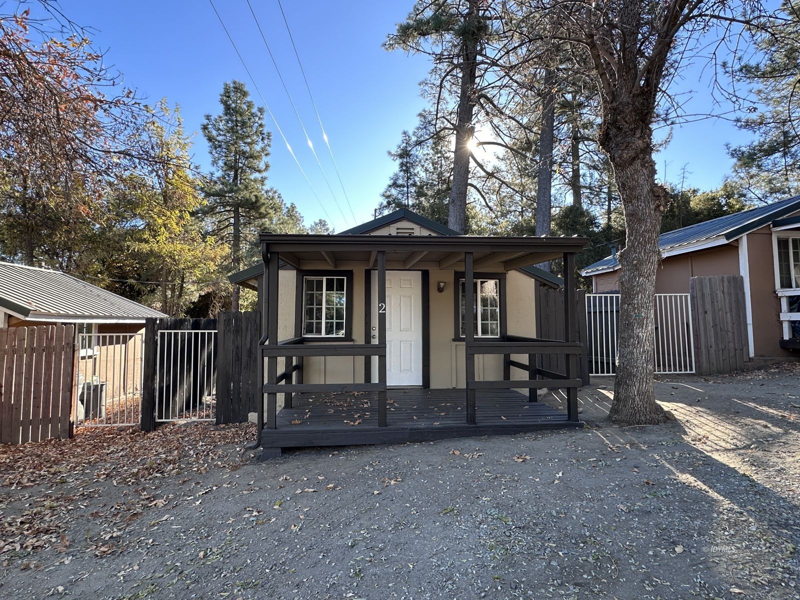 a view of a house with a yard and wooden fence