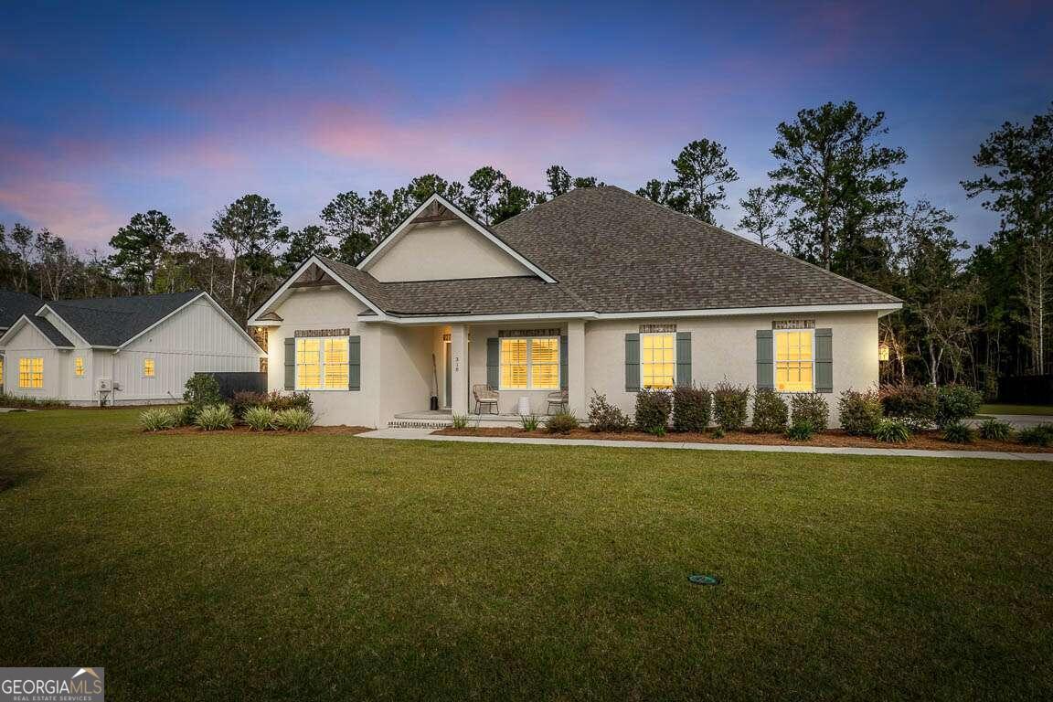 a front view of a house with a yard