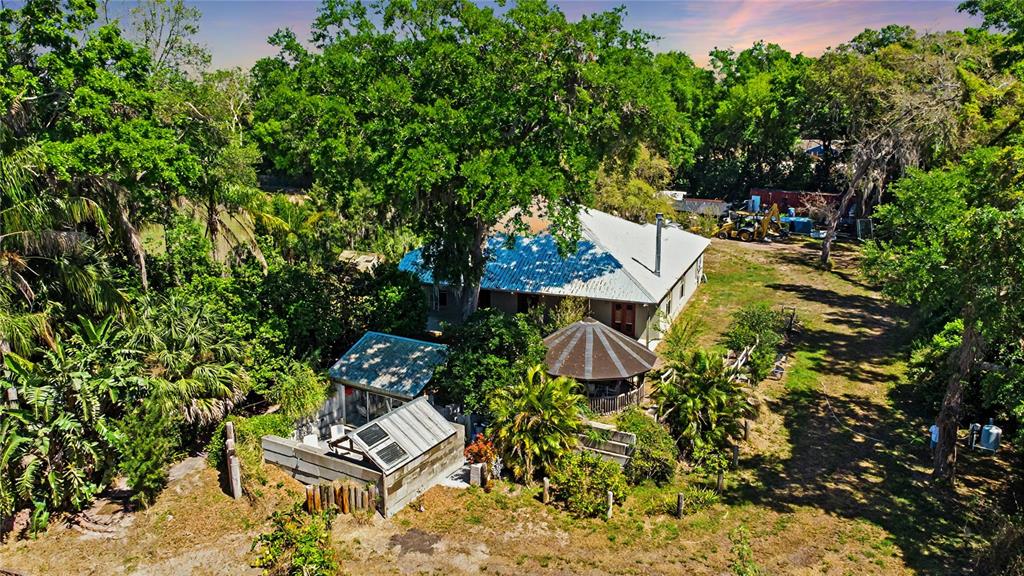 an aerial view of a house with a yard and garden