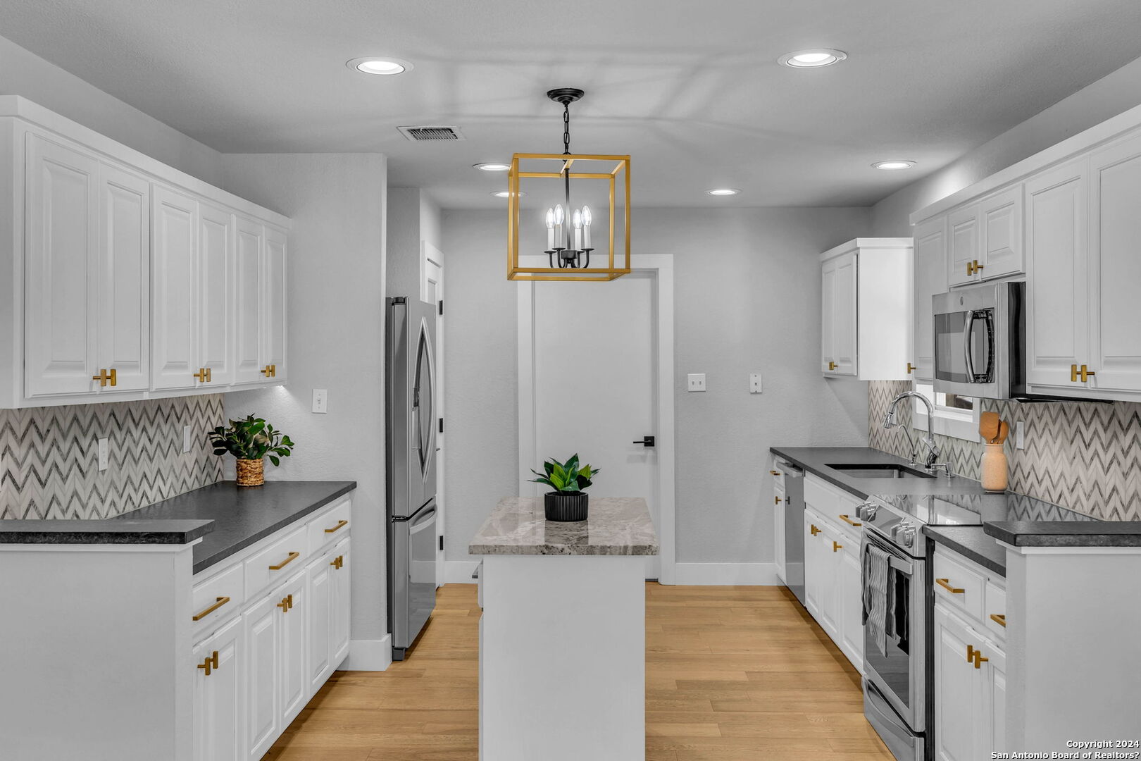 a open kitchen with stainless steel appliances granite countertop a sink stove and refrigerator