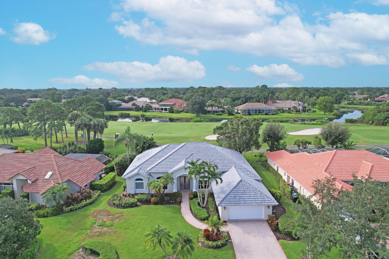 an aerial view of a house with garden space and a street view