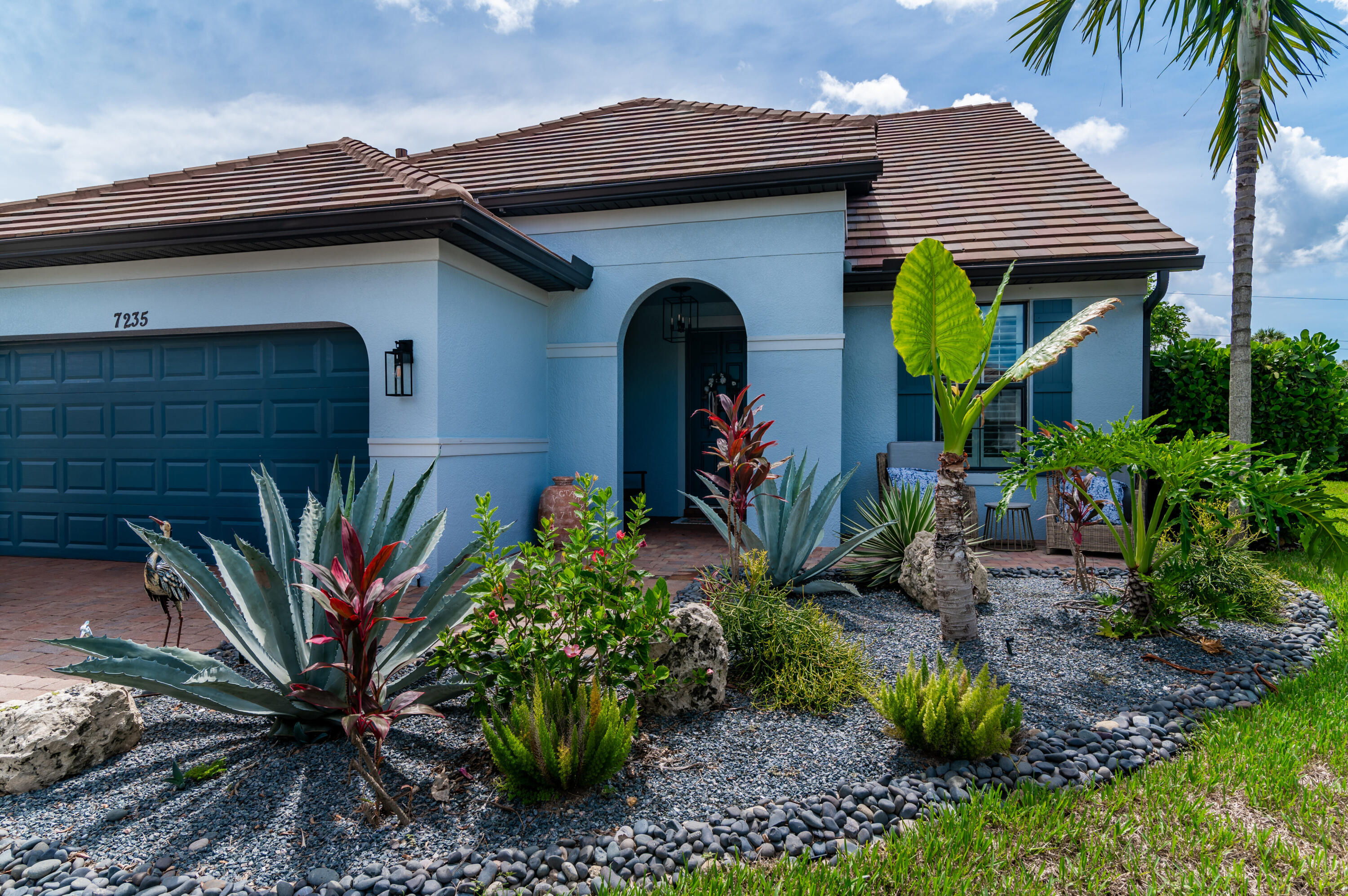 a front view of a house with garden