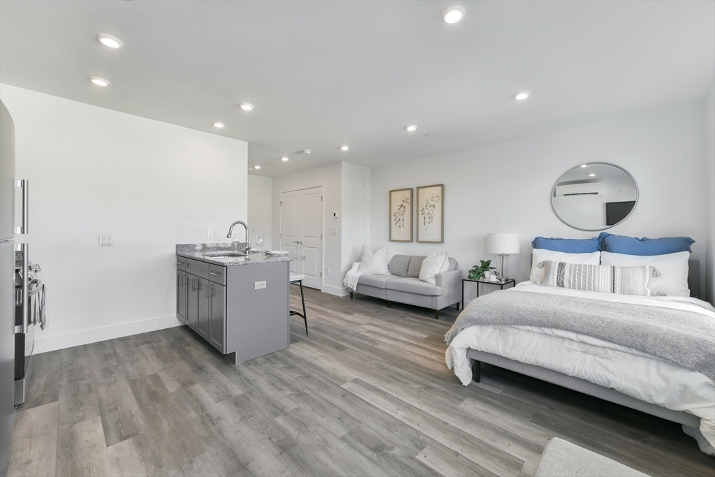 a spacious bedroom with a bed and a chandelier