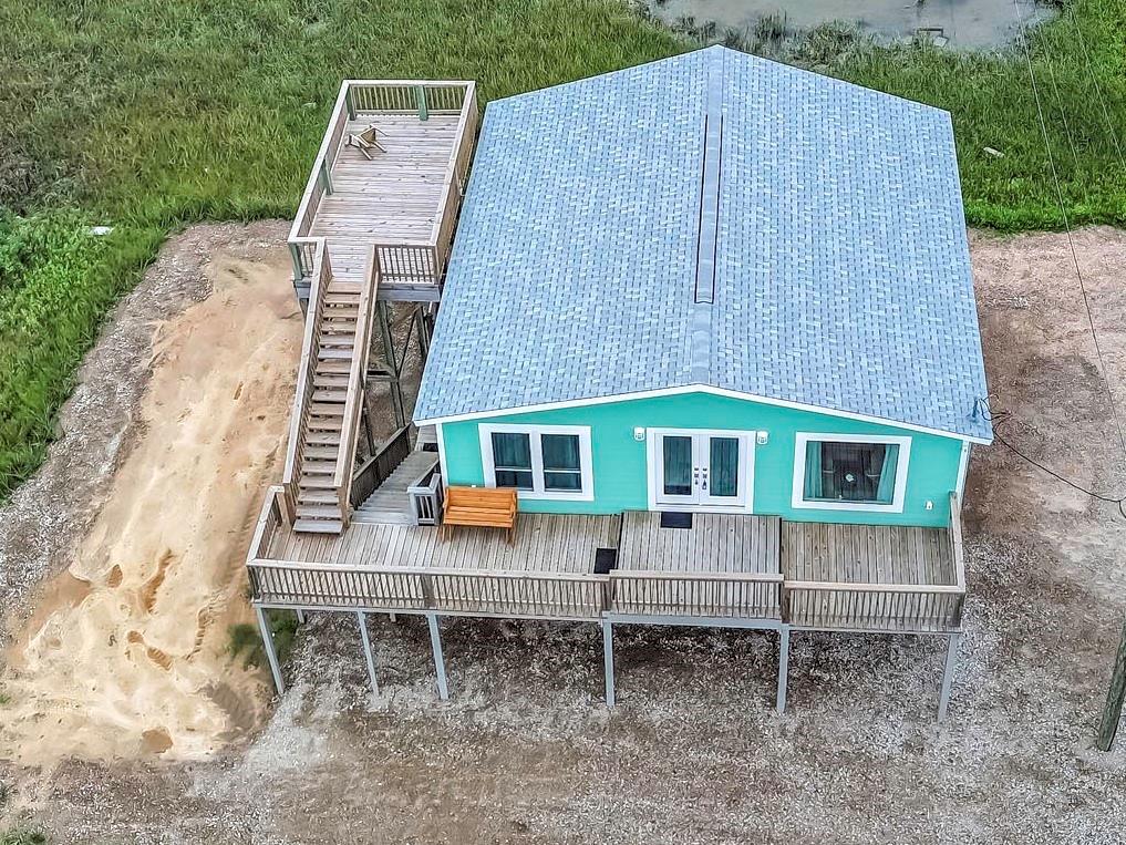 a backyard of a house with table and chairs