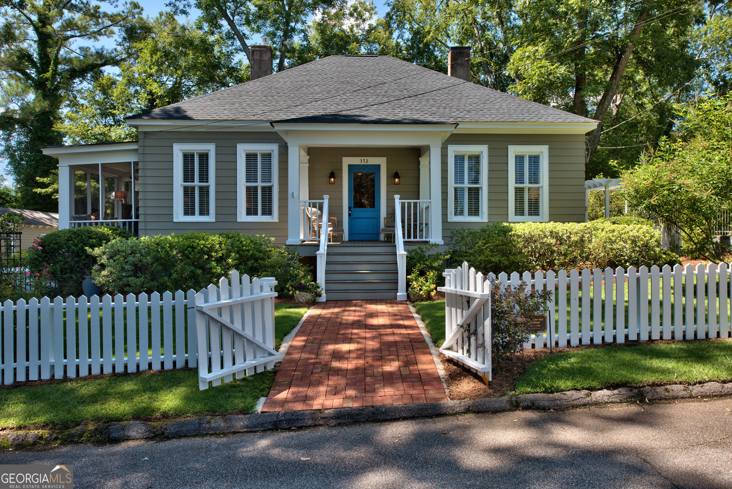 a front view of a house with a garden