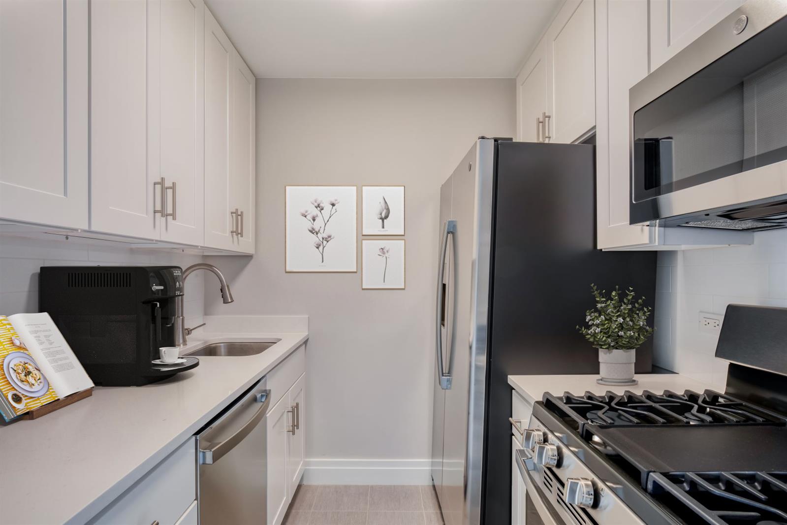 a kitchen with stainless steel appliances a stove a refrigerator and a cabinets