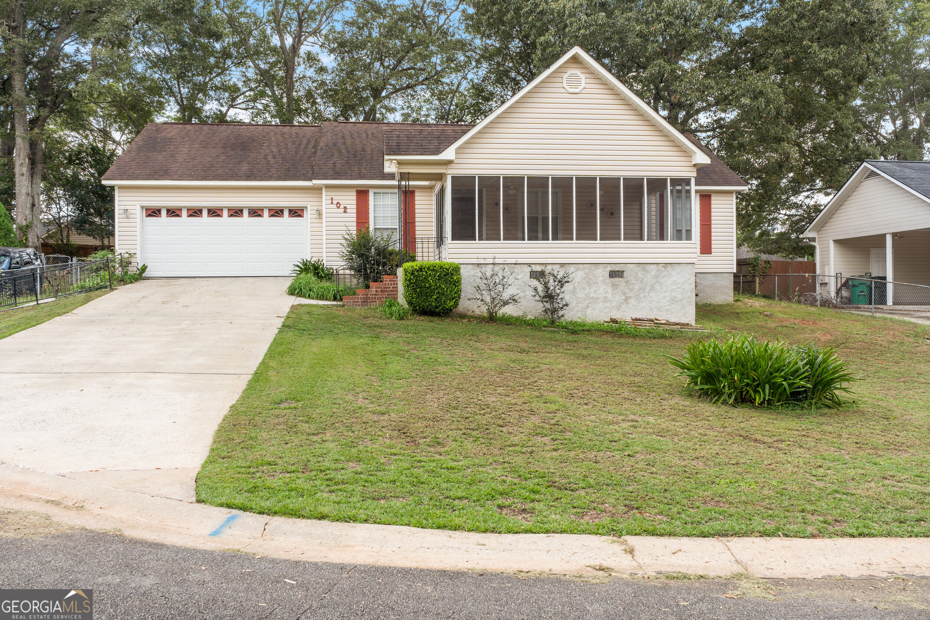 a view of a house with a yard and garage