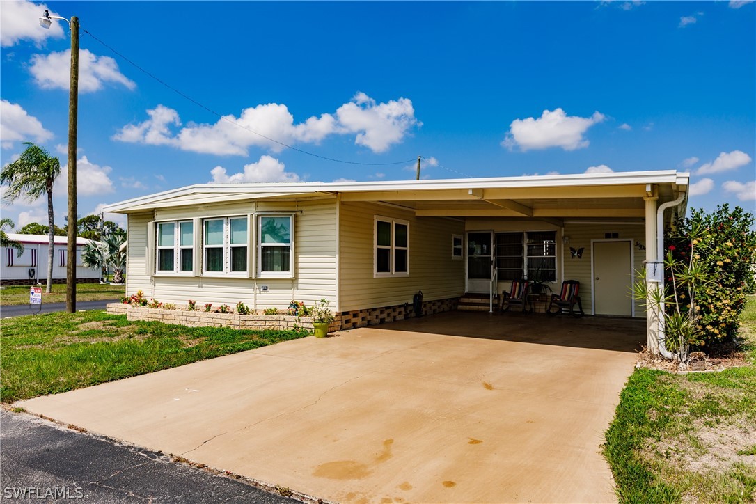 a view of a house with backyard and sitting area