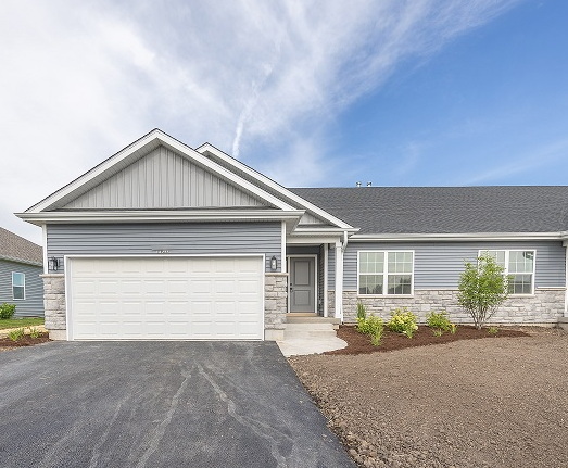 a front view of house with garage and yard